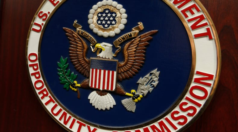 FILE - The emblem of the U.S. Equal Employment Opportunity Commission (EEOC) is displayed on a podium in Vail, Colo., Feb. 16, 2016. (AP Photo/David Zalubowski, File)