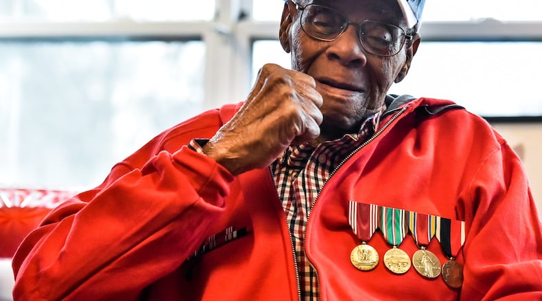 World War II veteran William “Jimmy” Phillips gives a fist pump after receiving his long awaited war medals during a ceremony Thursday, Feb. 22 at Woodlands of Middletown Assisted Living facility. Phillips, who turns 92 next month, has waited nearly 70 years since his discharge to receive his medals. He was awarded the Army Good Conduct Medal, Europe-Africa Middle Eastern Campaign Medal, World War II Victory Medal and the Army of Occupation Medal during the ceremony. Jerry Ferris and Randy Howson with the Military Order of the Purple Heart Chapter 31 presented the medals. NICK GRAHAM/STAFF