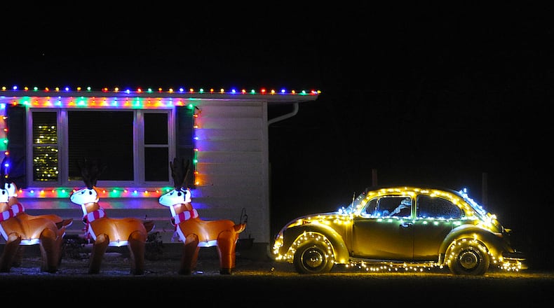 Tis the season. Eight blowup raindeer and Santa in his Volkswagen Beetle in a yard on Dayton Road near Enon. MARSHALL GORBY\STAFF