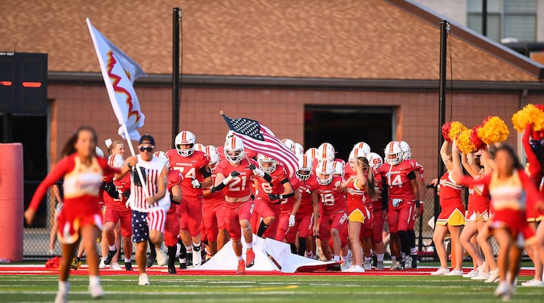 The Fenwick High School football team takes the field against Franklin earlier this season. KYLE HENDRIX / CONTRIBUTED