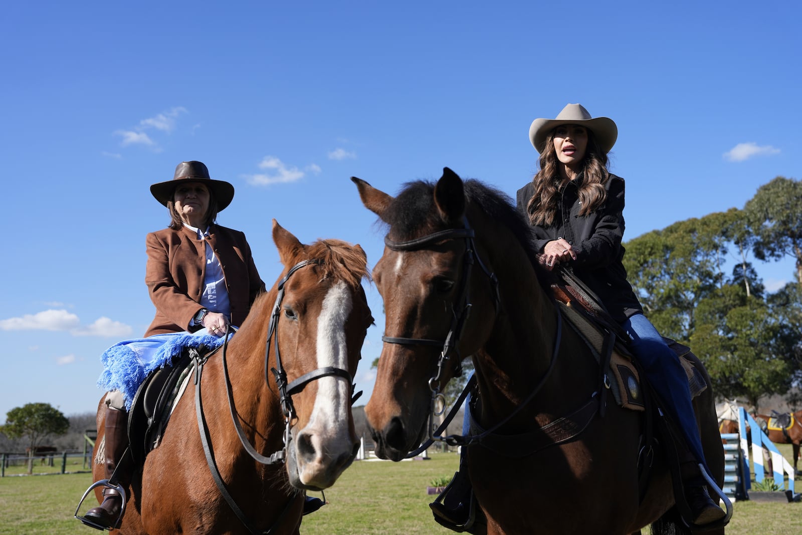 U.S. Homeland Security Secretary Kristi Noem, right, and Argentine National Security Minister Patricia Bullrich sit on horses as they speak to the press upon arrival to the Campo De Mayo Military Base in Buenos Aires province, Argentina, Monday, July 28, 2025. (AP Photo/Alex Brandon, Pool)