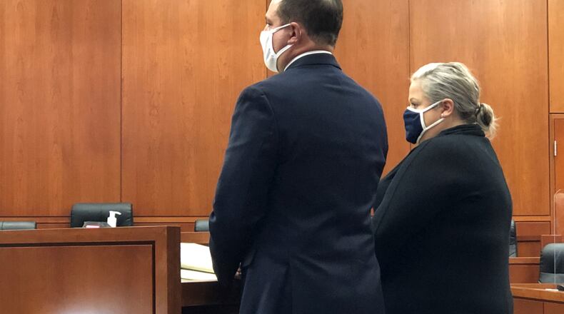 Alison McGaughey, 40, of Kettering, pleaded guilty to two charges on Monday stemming from her alleged embezzlement of more than $287,000. She is pictured with lawyer Jason Cavinder.