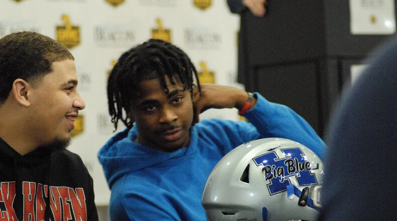 Hamilton's Gabe Verdon (left) and teammate Jaylan Garrett talk during Wednesday's GMC Signing Day event in Sharonville. Chris Vogt/CONTRIBUTED
