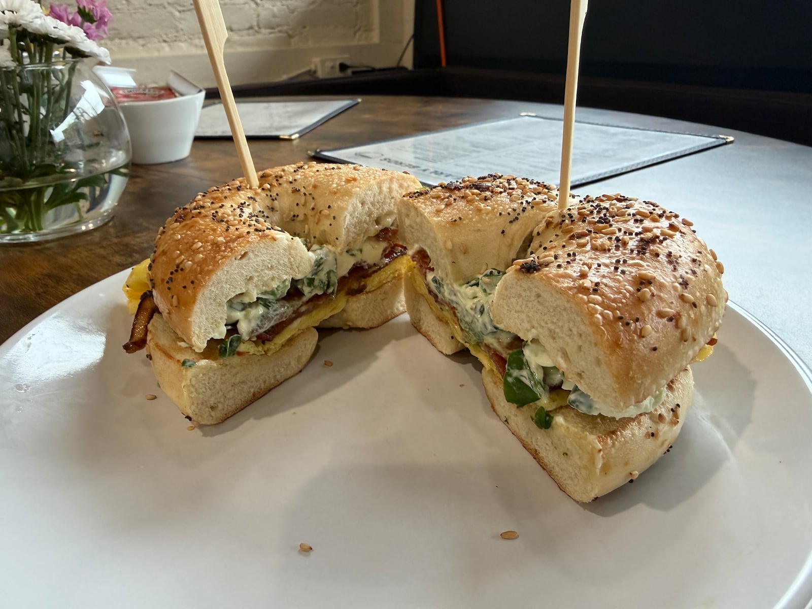 The Bee Sting Bagel at Early Berds Cafe & Coffee features hot honey bacon on an everything bagel, topped with egg and jalapeno cream cheese. The new business at 202 N. Third St. in Hamilton is open daily for breakfast and brunch. ERIC SCHWARTZBERG/STAFF