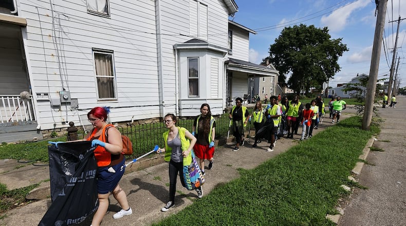 A group of nearly fifty people with HYPE Hamilton youth mentoring program, led by pastor Shaquila Mathews, cleaned up trash as a community service Thursday, July 28, 2022 in Hamilton. NICK GRAHAM/STAFF