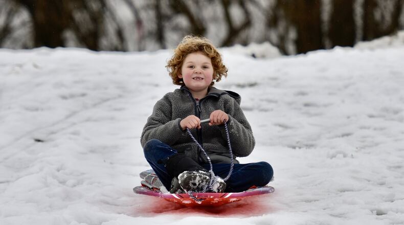 Xavier Radel, 6, sleds down a hill at Watermark Church Thursday, Jan. 17 in Monroe. NICK GRAHAM/STAFF
