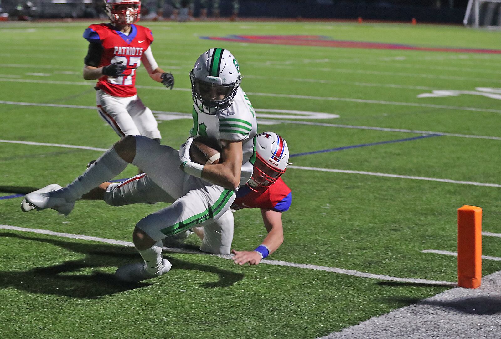 Carroll's Elliot Braun tackles Badin's Eric Rawlings as he crosses the goal line for a touchdown. BILL LACKEY/STAFF