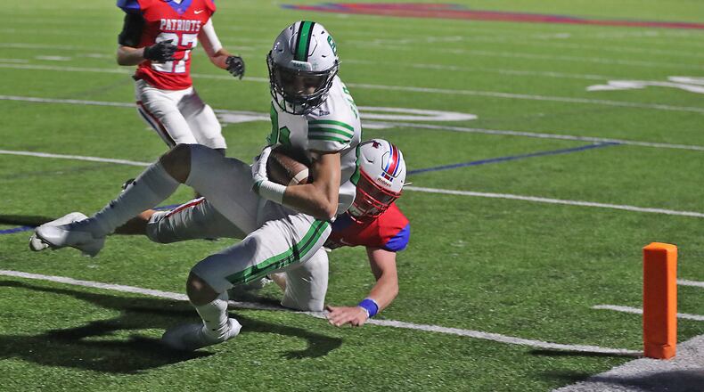 Carroll's Elliot Braun tackles Badin's Eric Rawlings as he crosses the goal line for a touchdown. BILL LACKEY/STAFF