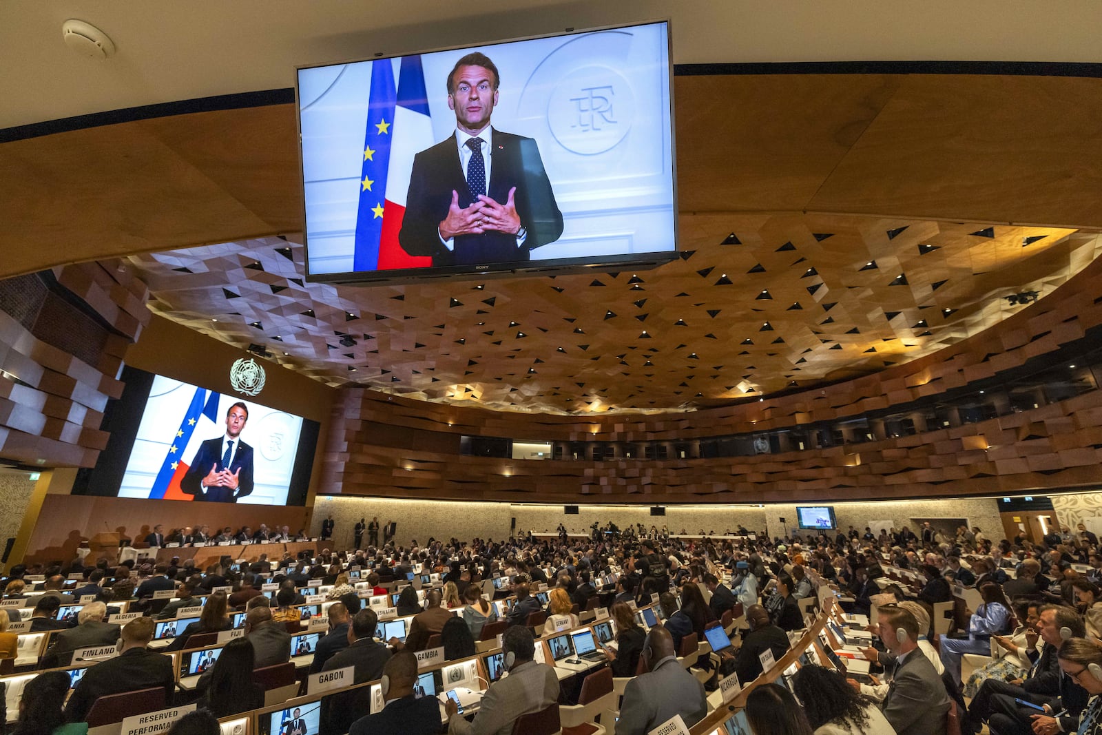 French President, Emmanuel Macron, delivers a statement on a video about the historic agreement on how to combat future pandemics, aimed at avoiding a repeat of the mistakes made during the Covid-19 crisis, during the 78th World Health Assembly (WHA78) at the European headquarters of the United Nations in Geneva, Switzerland, Tuesday, May 20, 2025. (Magali Girardin/Keystone via AP)
