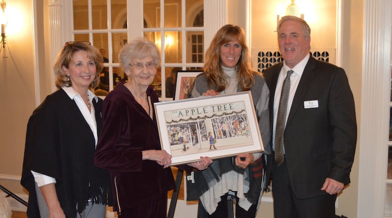 Chamber of Commerce President Kelli Riggs, Barb Clawson, Cheri Corcoran and Chamber board vice chair Neal Kamphaus pose at the presentation of the Business of the Year recognition of the Apple Tree. CONTRIBUTED/BOB RATTERMAN