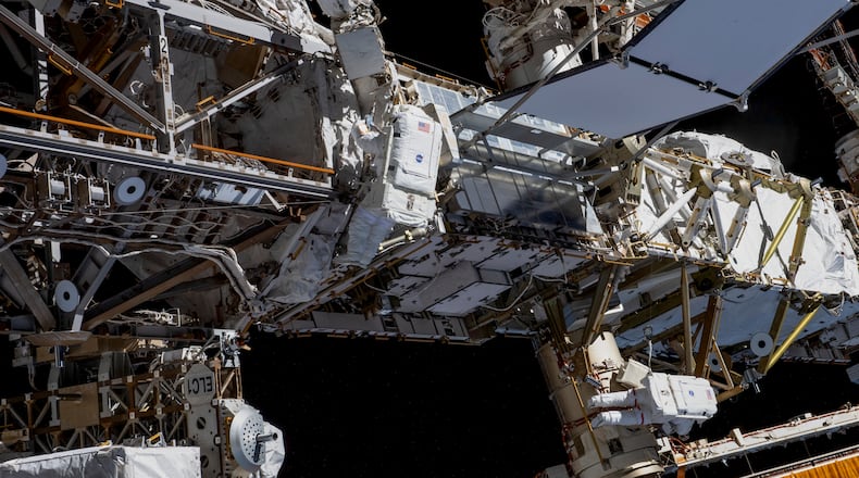 A photo provided by NASA shows Expedition 70 Flight Engineers Loral O’Hara, center, and Jasmin Moghbeli, right, tethered to the International Space Station’s port truss structure during a spacewalk on Nov. 1, 2023. While working on maintenance outside the International Space Station this month, two NASA astronauts lost track of a tool bag. Now it’s floating in space. (NASA via The New York Times) — NO SALES; FOR EDITORIAL USE ONLY —