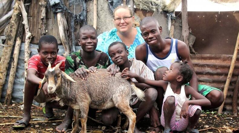 Dr. Kelly Crowdis is an American veterinarian who has worked in Haiti for the past 10 years. Hamilton shop Made for Love is holding a fundraiser to support efforts by Crowdis, including her “Give a Kid a Kid” program. The program has helped give Haitians a sustainable income by providing families with a baby goat. Crowdis is pictured with some of the children she has helped. CONTRIBUTED