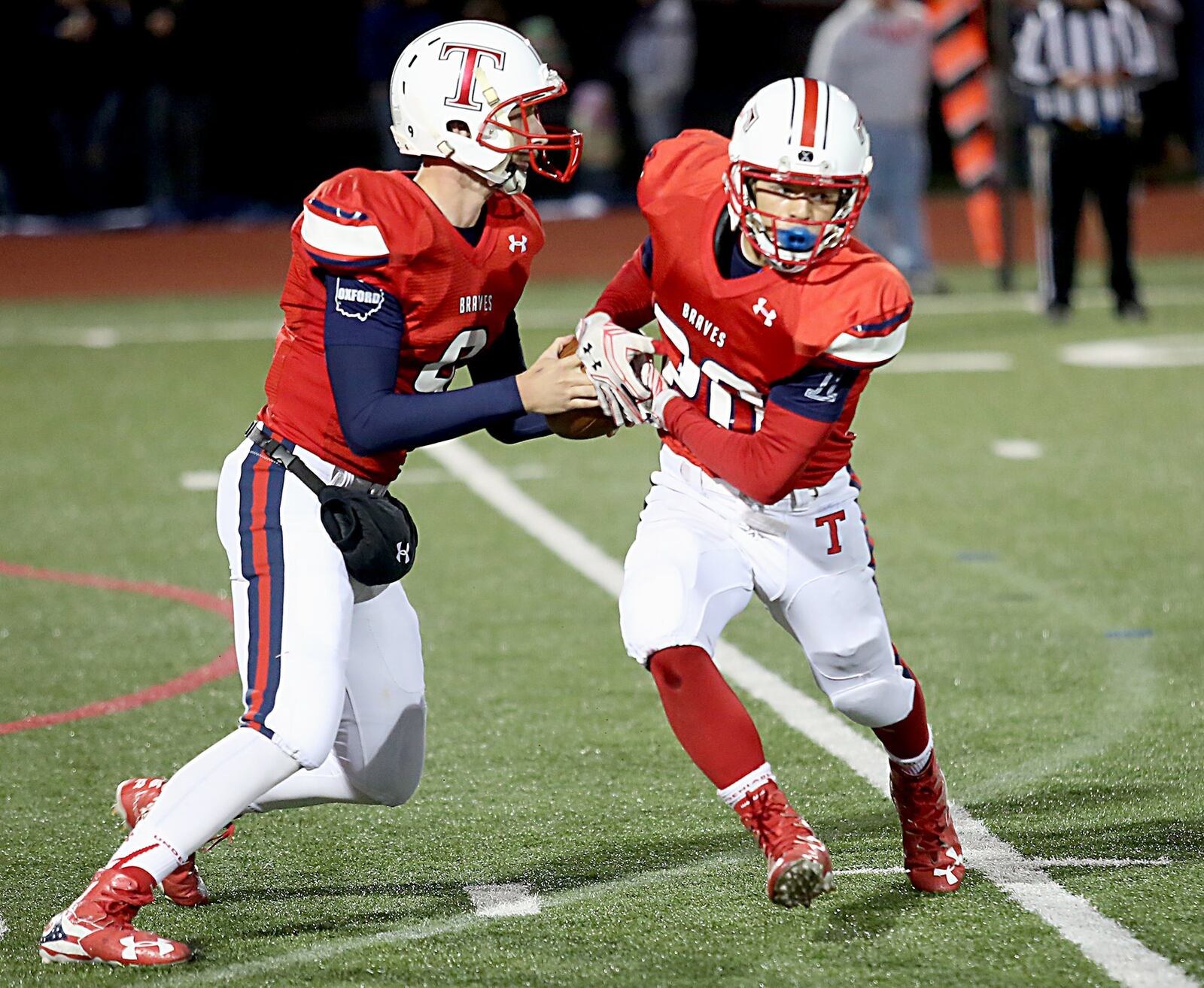 Talawanda quarterback Logan Kamphaus fakes a handoff to running back Blake Bryan during a game against Edgewood in Oxford on Oct. 14, 2016. CONTRIBUTED PHOTO BY E.L. HUBBARD