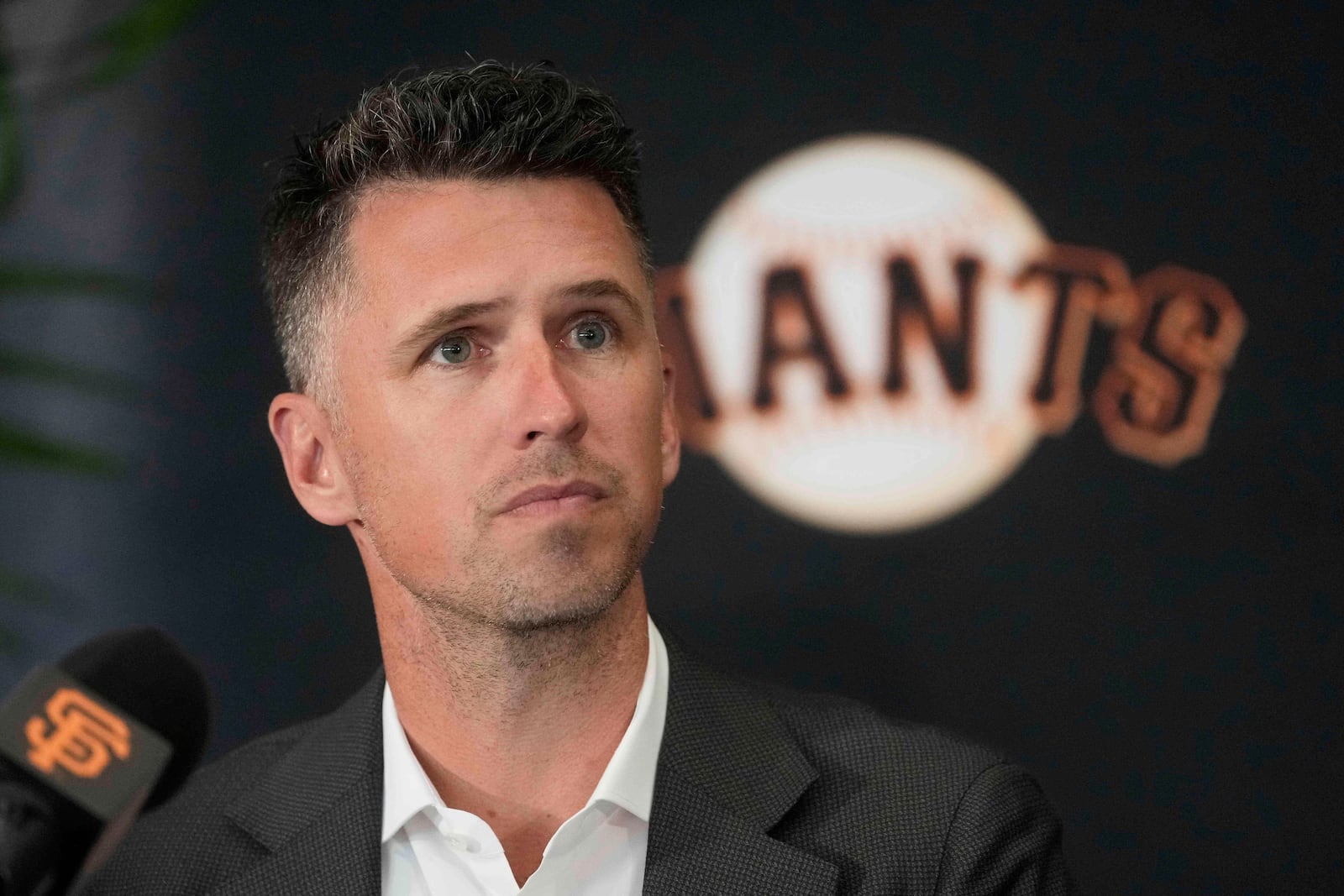 San Francisco Giants President of Baseball Operations Buster Posey listens at a news conference before a baseball game between the Giants and the Cleveland Guardians in San Francisco, Tuesday, June 17, 2025. (AP Photo/Jeff Chiu)