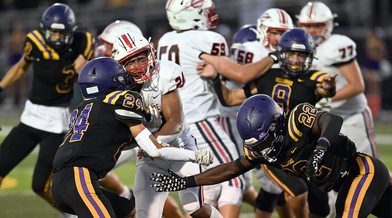 Bellbrook High School's Christian Burchfield (left) and Gage Cameron hit Tippecanoe High School's Xavier Melton during their game on Friday, Aug. 22 at Miami Valley South Stadium. Tippecanoe won 21-0. NICK FALZERANO / CONTRIBUTED PHOTO