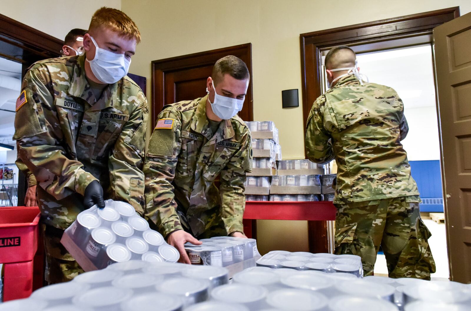 Spc. Michael Doyle, left, Spc. Kyle Eden, middle, and Spc. Tray Bash, right, with Ohio Army National Guard Delta Company 237th deliver food from Shared Harvest Food Bank to The Salvation Army on First Avenue in Middletown Tuesday, April 21, 2020. National Guard members have been activated around the area to help pack and distribute food during the coronavirus pandemic. The Salvation Army continues to serve food items and meals to those in need in the community with the help of their staff and volunteers. NICK GRAHAM / STAFF