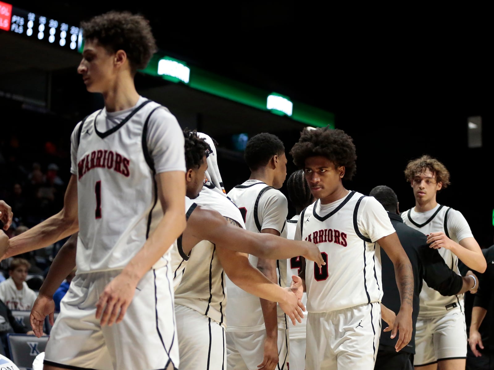 Wayne senior Kaden Post (1), Sante Jones (0), and Alphonso Ward (20) come off the floor for a final time during a Division I regional semifinal game on Wednesday, March 11, 2026, at the Cintas Center in Cincinnati. Princeton won 62-41. STEVEN WRIGHT / STAFF
