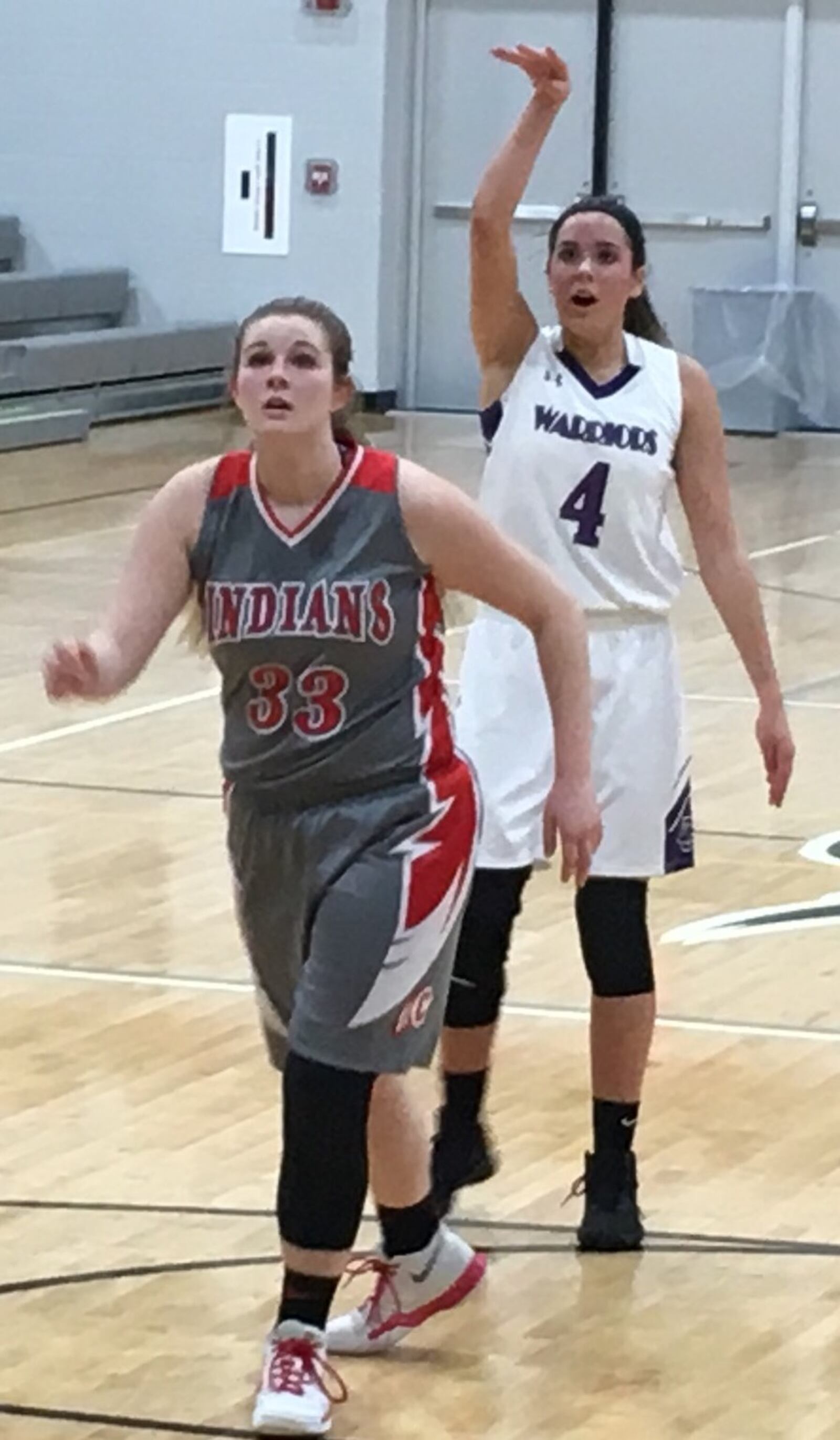 Dayton Christian’s Casey Darkow (4) follows through on a shot as Carlisle’s Abby Erisman prepares to get a rebound Wednesday night during a Division III sectional semifinal at Covington. RICK CASSANO/STAFF