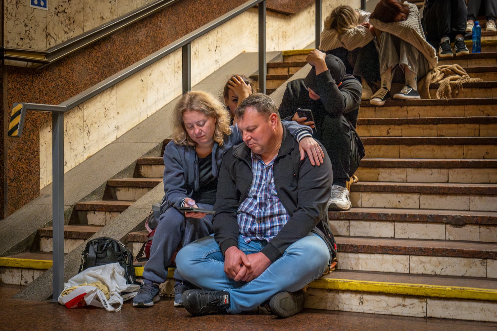 People rest in a metro station, being used as a bomb shelter, during a Russian drones attack in Kyiv, Ukraine, early Friday, June 6, 2025. (AP Photo/Dan Bashakov)