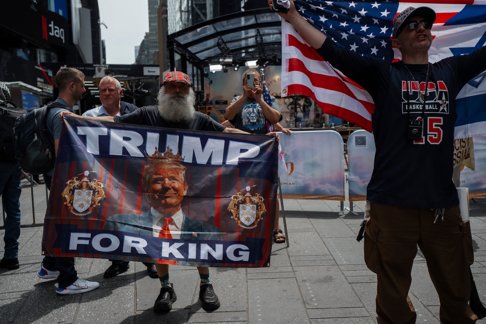Supporters of President Donald Trump hold pro-Trump flags in Times Square during a protest against U.S. strikes on Iran, Sunday, June 22, 2025, in New York. (AP Photo/Olga Fedorova)