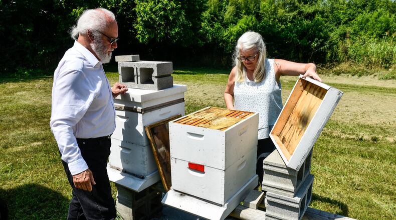 Beekeepers Yvonne Campbell Johnson (right) and Johnny Mack Brown with EZ Honey in Fairfield. NICK GRAHAM/STAFF