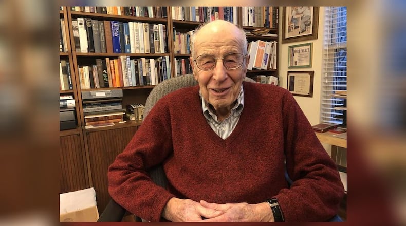 Dr. Al Miller, seen here at age 97, a Holocaust survivor, was an optometrist in Hamilton for more than 40 years before retiring and moving to Deerfield Twp. He converted a bedroom into an extensive library. RICK McCRABB/STAFF