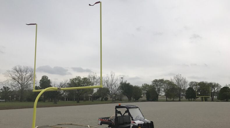 A new turf football field courtesy of the NFL- will be laid in Dayton at the site of the old Park Side Homes off Keowee Street. The tribute field, a near $500,000 commitment by the NFL to the city of Dayton in recognition for the city s stored history with the league through the Dayton Triangles, is to be put in place the week after Memorial Day. The field s gravel base and 100-yard long cement pad for bleachers alongside the field are done and the two goal posts are up. Tom Archdeacon/STAFF The field will be used by youth groups, adult teams member. This site is the alternate site after original site at Triangle Park near where the first NFL game was played between Dayton Triangles and Columbus Panhandles Oct 3, 1920 was found to have possible Indian artifacts or even be a burial site beneath the surface. I talk to Joe Parlette, Dayton s assistant city manager, and the guy in charge of the project on this end.