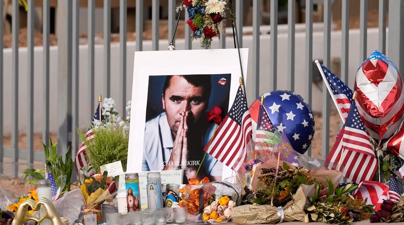 A makeshift memorial grows in size at the Turning Point USA headquarters after the shooting death at a Utah college last Wednesday of Charlie Kirk, the 31-year-old founder and CEO of the organization, Wednesday, Sept. 17, 2025, in Phoenix. (AP Photo/Ross D. Franklin)