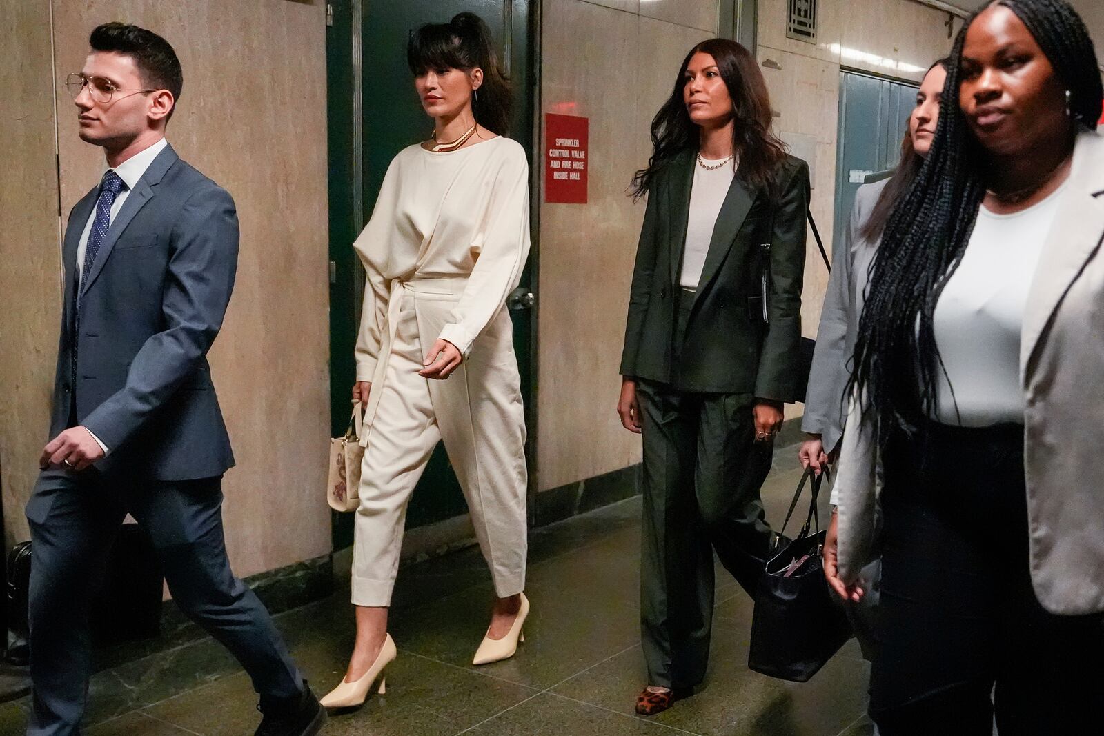 Tarale Wulff, second from left, Dawn Dunning, third from left, and attorney Lindsay Goldbrum, second from right, arrive for Harvey Weinstein's retrial at Manhattan criminal court, Wednesday, April 23, 2025, in New York. (AP Photo/Julia Demaree Nikhinson)