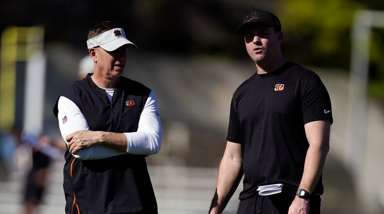 Cincinnati Bengals head coach Zac Taylor, right, talks to defensive coordinator Lou Anarumo during NFL football practice Wednesday, Feb. 9, 2022, in Los Angeles. The Cincinnati Bengals play the Los Angeles Rams in the Super Bowl Feb. 13. (AP Photo/Marcio Jose Sanchez)