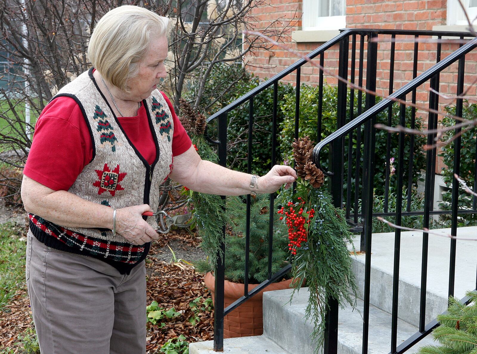 In this 2006 file photo, Lois Kingsley hangs decortations on the front porch of the Elisha Morgan Mansion in Fairfield. 