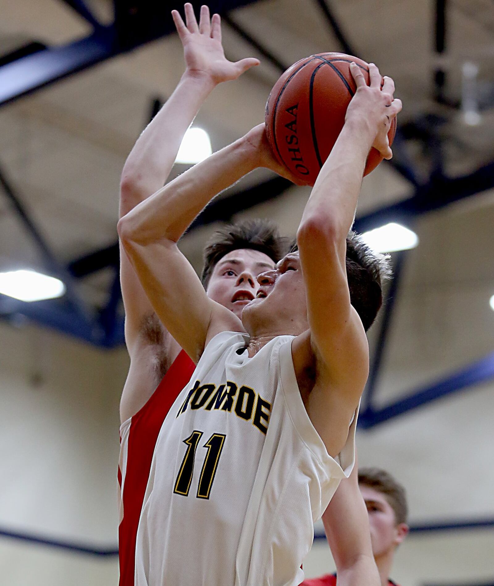 Monroe guard Thryceton Deckard draws a foul from Talawanda’s Justin Boggs during Tuesday night’s game at Monroe. CONTRIBUTED PHOTO BY E.L. HUBBARD