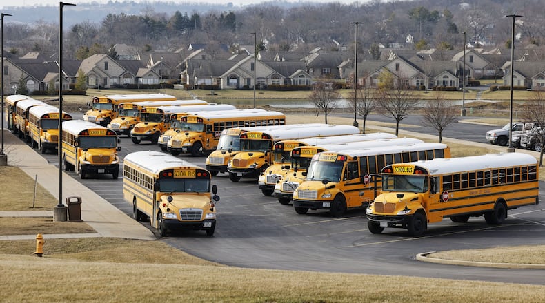 School buses are seen waiting to transport students at the Hamilton High School Freshman Campus on the city's west side around 2:30 p.m. Wed., Feb. 8, 2023. NICK GRAHAM/STAFF
