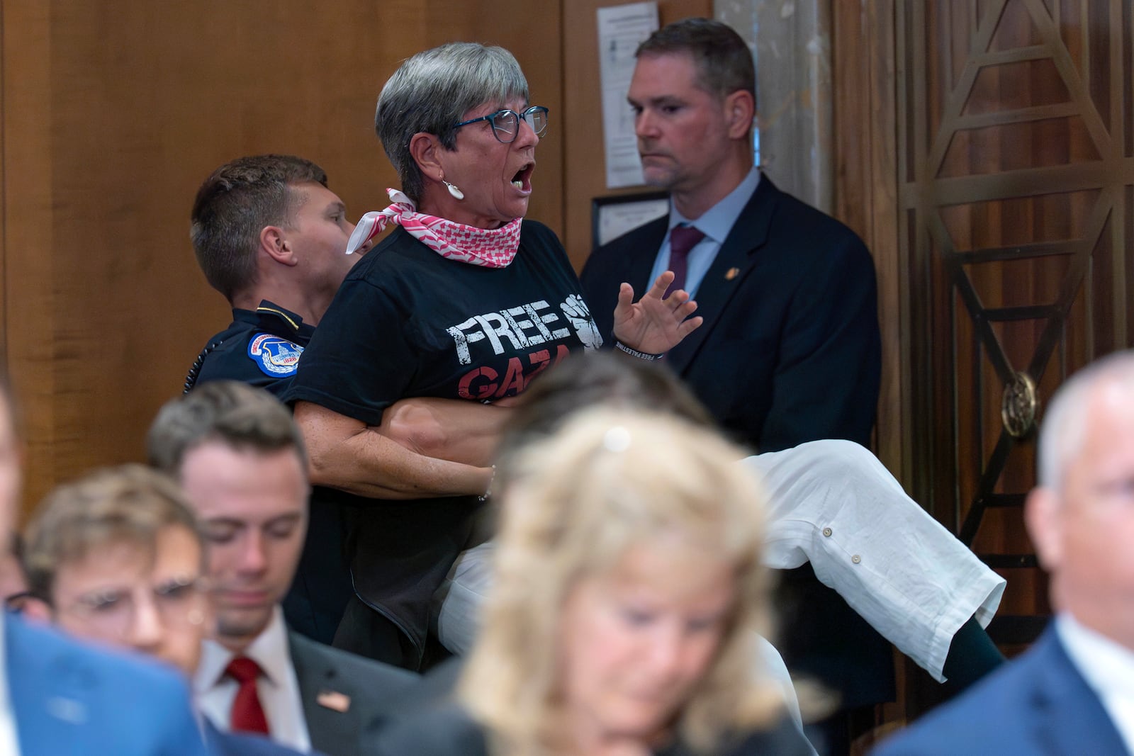 A demonstrator is taken out of the room as Secretary of State Marco Rubio testifies before the Senate Committee on Foreign Relations hearing to examine the President's proposed budget request for fiscal year 2026 for the Department of State on Capitol Hill in Washington, Tuesday, May 20, 2025. (AP Photo/Jose Luis Magana)
