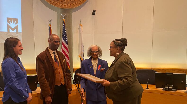 Celeste Didlick-Davis, right, accepts the 14th Robert "Sonny" Hill Jr. Humanitarian Award from, left, Middletown Mayor Nicole Condrey, Robbie Hill and Pat Hill. She received the award at the last city council meeting. RICK McCRABB/STAFF