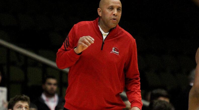E.L. Hubbard photo Miami University coach John Cooper gives instructions from the sideline last Saturday during the RedHawks’ 82-62 loss to Ball State at Millett Hall.