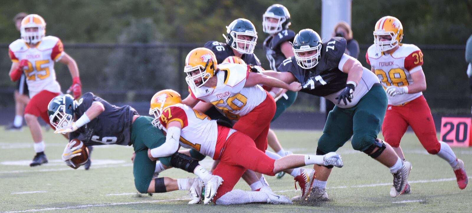 Fenwick’s Ben Gustely (47) and Adam DeBiasi (50) bring down Jake Watford (6) of McNicholas during Friday night’s game at Penn Station Stadium in Cincinnati. Fenwick won 57-26. CONTRIBUTED PHOTO BY ANGIE MOHRHAUS
