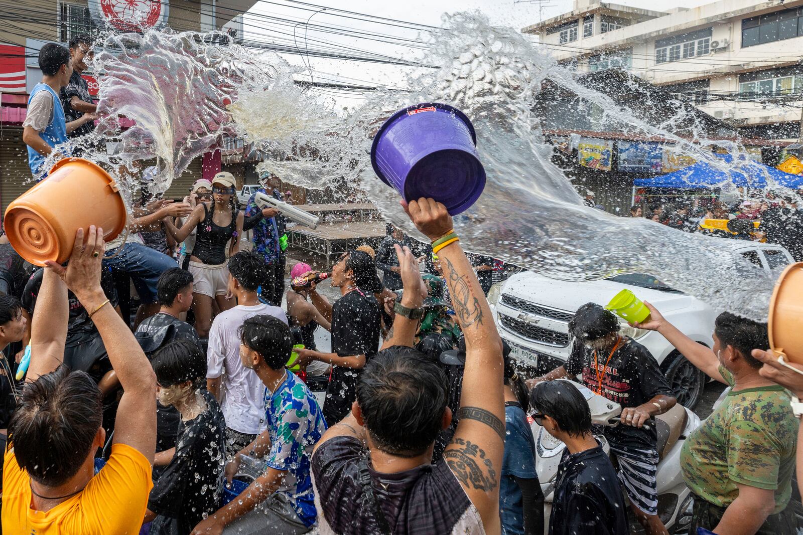 People splash water during the Songkran water festival to celebrate the Thai New Year in Prachinburi Province, Thailand, Sunday, April 13, 2025. (AP Photo/Wason Wanichakorn)