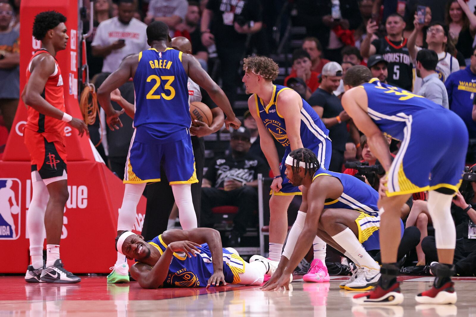 Golden State Warriors' Jimmy Butler III writhes in pain after injuring himself in 1st quarter against Houston Rockets in Game 2 of First Round of NBA Playoffs at Toyota Center in Houston, Texas on Wednesday, April 23, 2025. (Scott Strazzante/San Francisco Chronicle via AP)