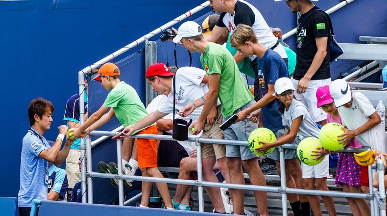 Fans will be unable to see some of the world’s best tennis players after the Western & Southern Open was moved from Mason to New York City for one year. Here, Yoshihito Nishioka signs autographs after beating Ales de Minaur last year. NICK GRAHAM/STAFF