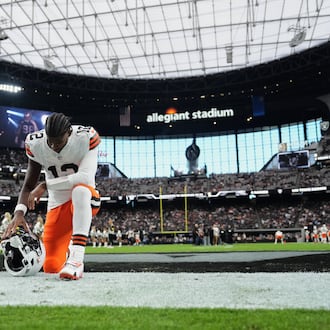 Cleveland Browns quarterback Shedeur Sanders (12) kneels in the end zone before an NFL football game against the Las Vegas Raiders, Sunday, Nov. 23, 2025, in Las Vegas. (AP Photo/Candice Ward)