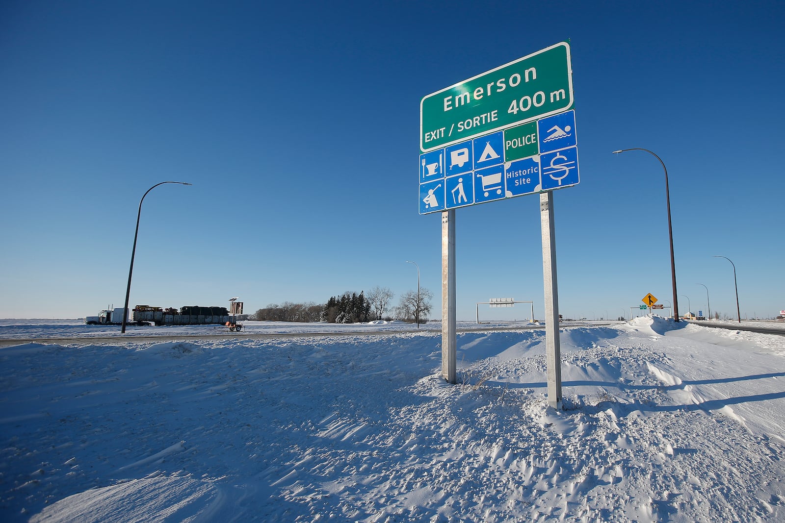 FILE - Road signage is posted just outside of Emerson, Manitoba, Thursday, Jan. 20, 2022. (John Woods/The Canadian Press via AP, File)