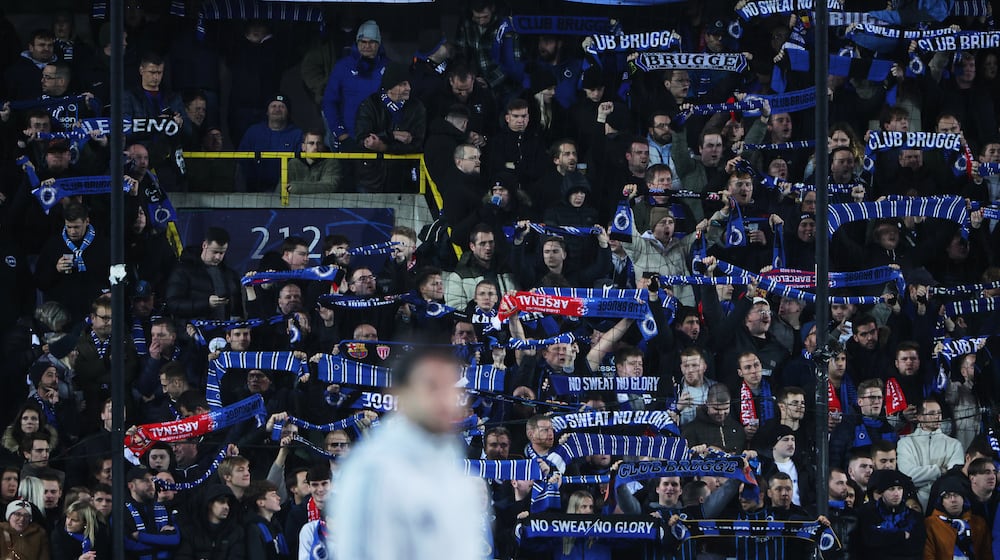 Fans hold up scarves to support their teams prior to the Champions League opening phase soccer match between Club Brugge and Arsenal in Bruges, Belgium, Wednesday, Dec. 10, 2025. (AP Photo/Omar Havana)