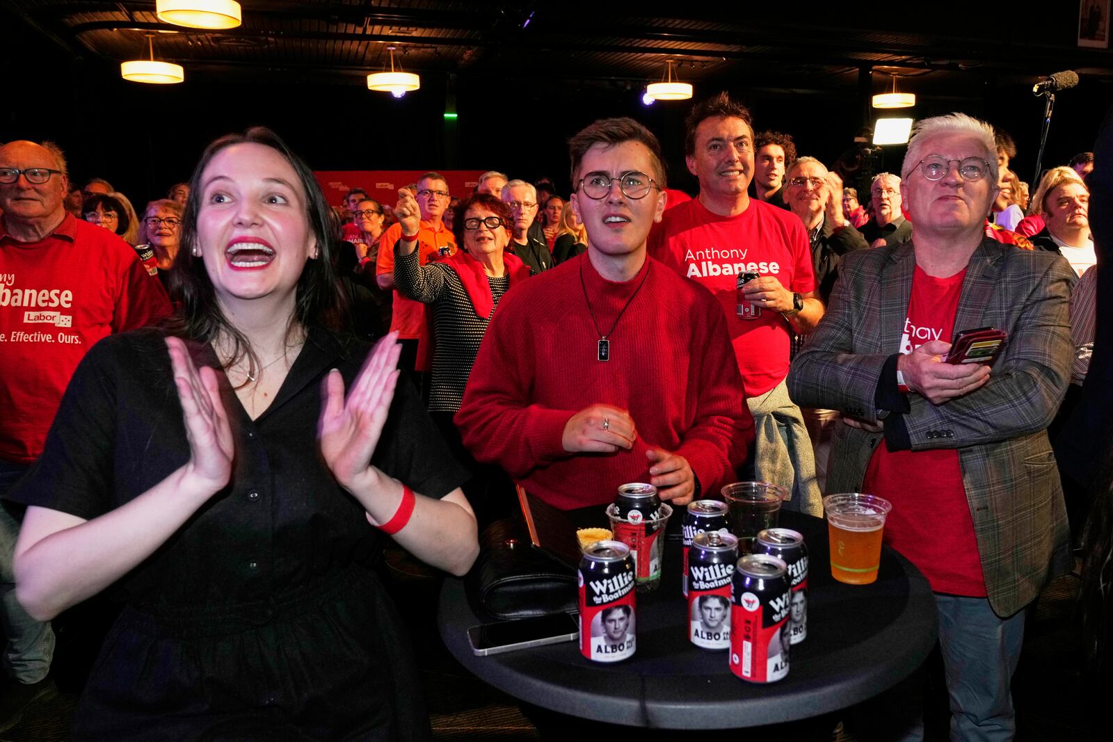 Labor Party supporters react as they watch as results are shown on a screen at their party headquarters event in Sydney, Saturday, May 3, 2025. (AP Photo/Rick Rycroft)
