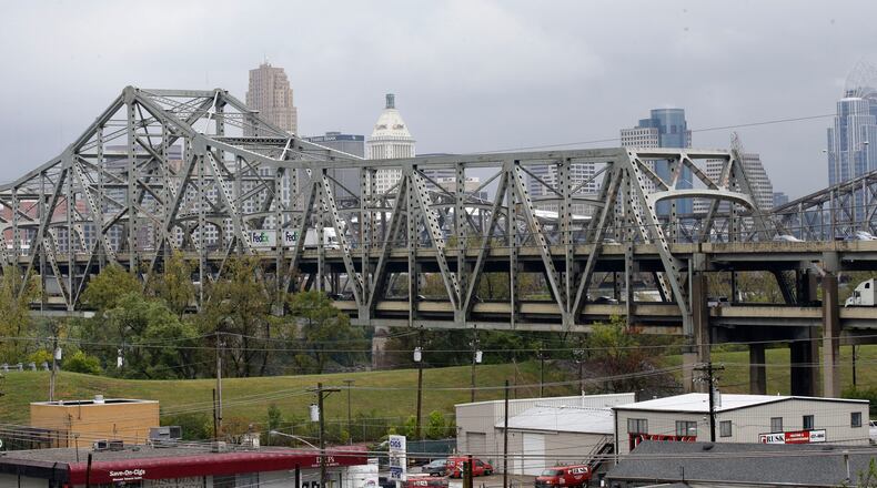 FILE – In this Oct. 7, 2014, file photo, traffic on the Brent Spence Bridge passes in front of the Cincinnati skyline while crossing the Ohio River to and from Covington, Ky. Governors from Ohio and Kentucky asked the federal government on Monday, Feb. 28, 2022 for $2 billion to fix and replace a bridge that became a symbol during the debate over the infrastructure bill passed last year. Overhauling the Brent Spence Bridge that connects Cincinnati with Northern Kentucky was a big selling point for President Joe Biden. (AP Photo/Al Behrman, File)