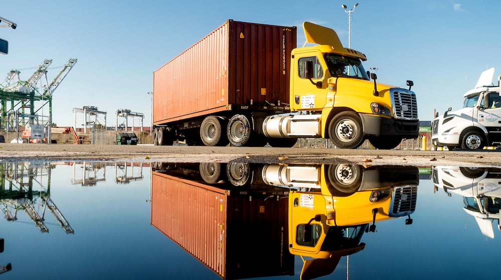 FILE - A truck departs from a Port of Oakland shipping terminal on Nov. 10, 2021, in Oakland, Calif. (AP Photo/Noah Berger, File)