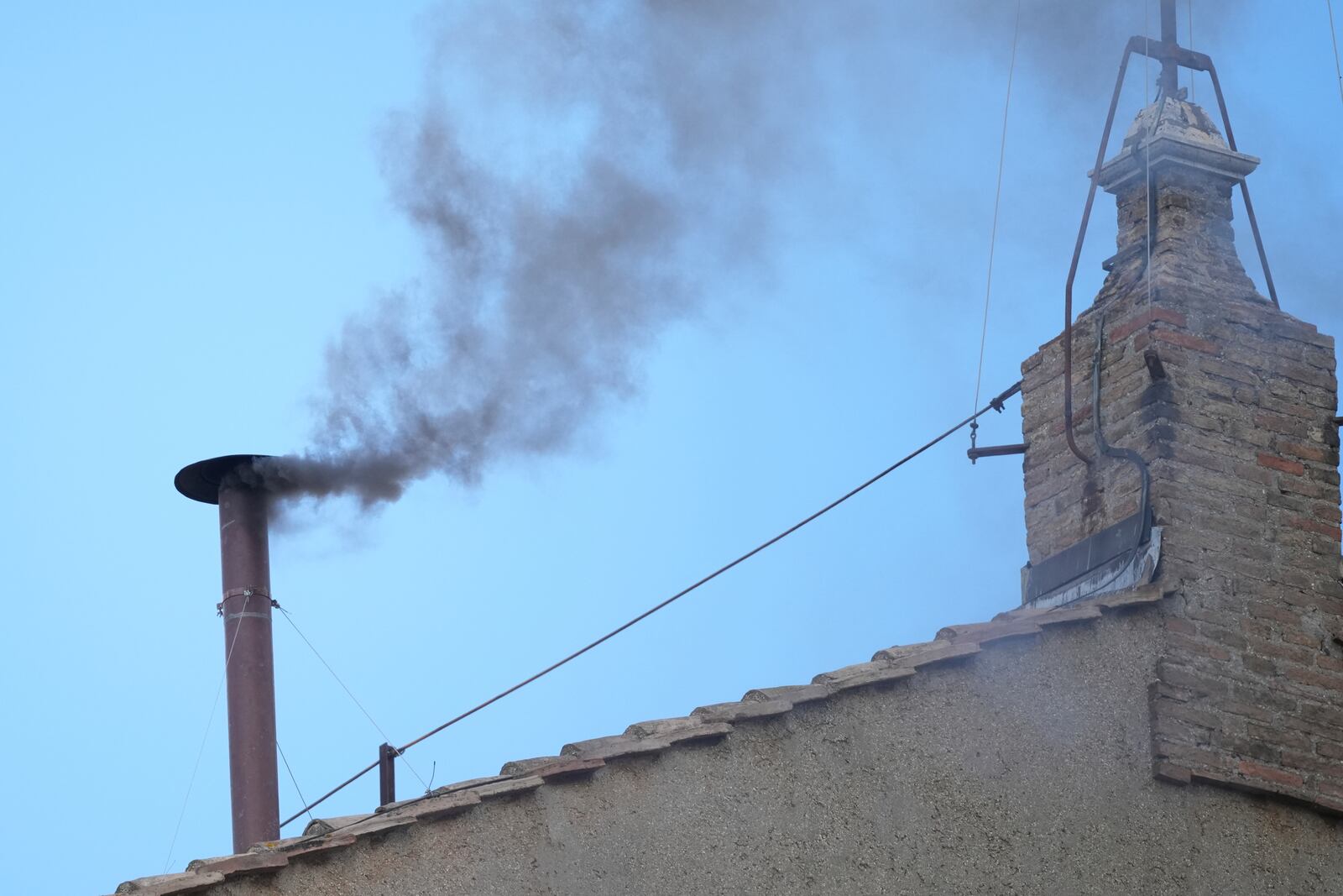 Black smoke billows from the chimney of the Sistine Chapel during the conclave to elect a new pope, at the Vatican, Thursday, May 8, 2025. (AP Photo/Andrew Medichini)