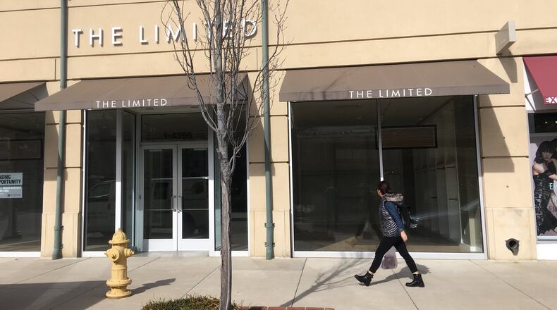 A shopper walks past the empty storefront at The Greene Town Center, which formerly occupied The Limited. KARA DRISCOLL/STAFF