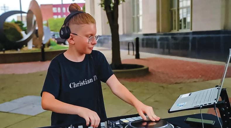 Christian DePew, or DJ Christian D, is seen in downtown Hamilton playing music at an event. CONTRIBUTED