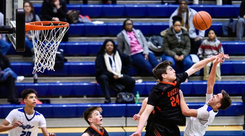 Lakota West’s Mitchell Wagner defends a shot by Hamilton’s Jaylen Robinson during their game Jan. 5 at the Hamilton Athletic Center. NICK GRAHAM/STAFF